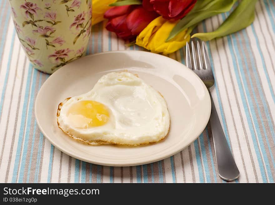 Tea, fried egg and tulips. Tea, fried egg and tulips