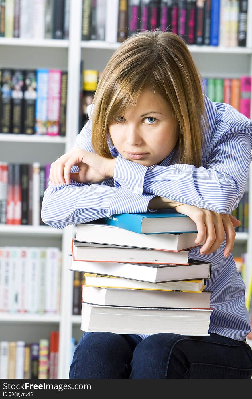 Young woman in the library with books for reading