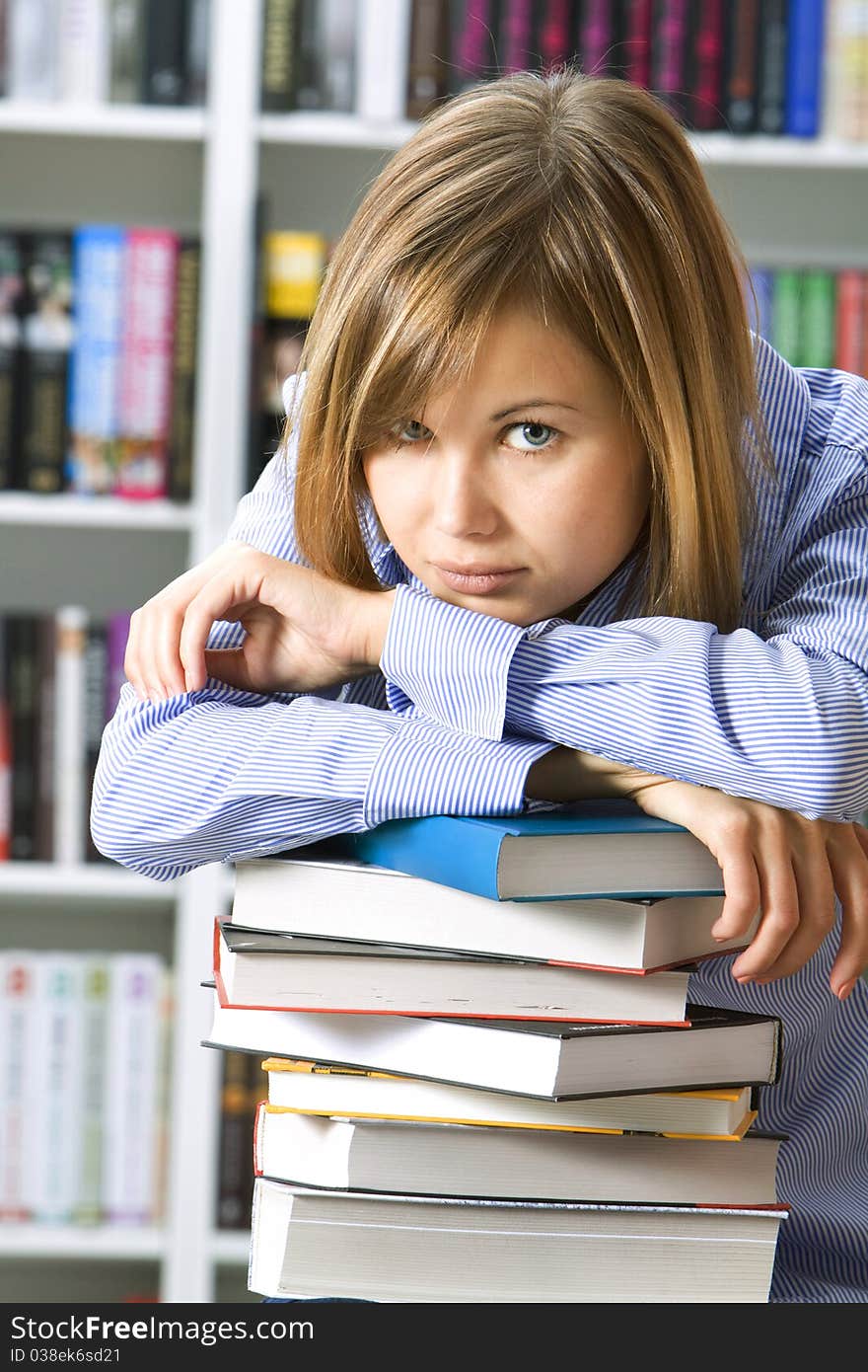 Young woman with books for reading in the library