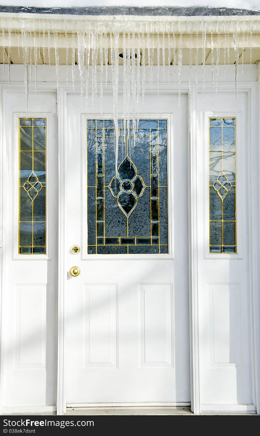 Bunch of icicles hanging over a roof.