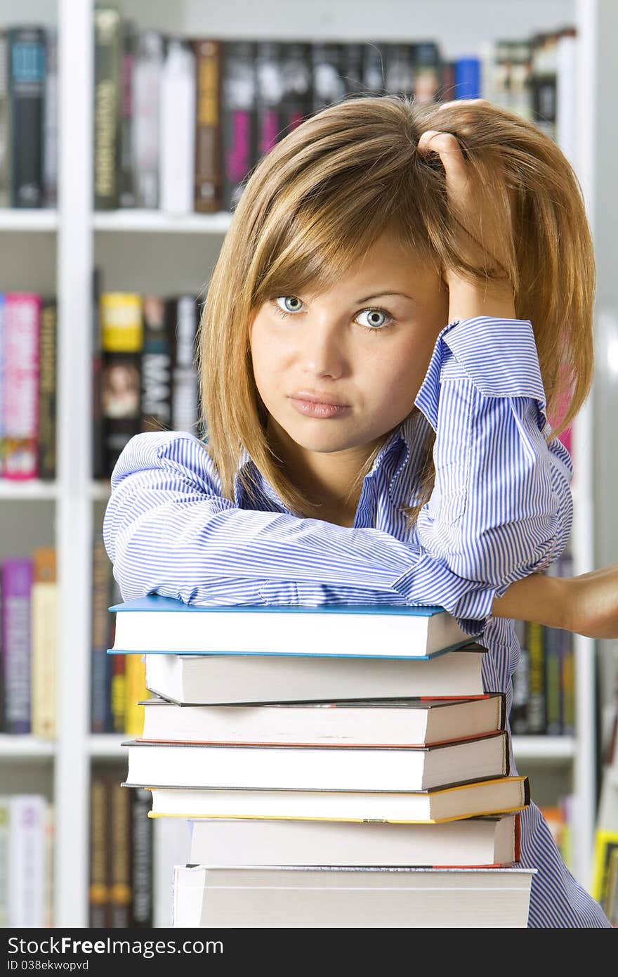 Young woman with books for reading in the library