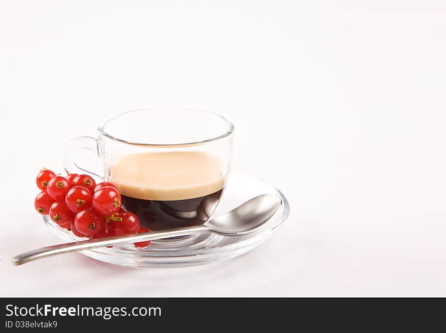 Photo of espresso with currant in glass cup on white isolated background. Photo of espresso with currant in glass cup on white isolated background