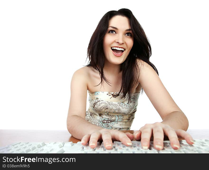 Closeup portrait of a young woman sitting on table and using a computer