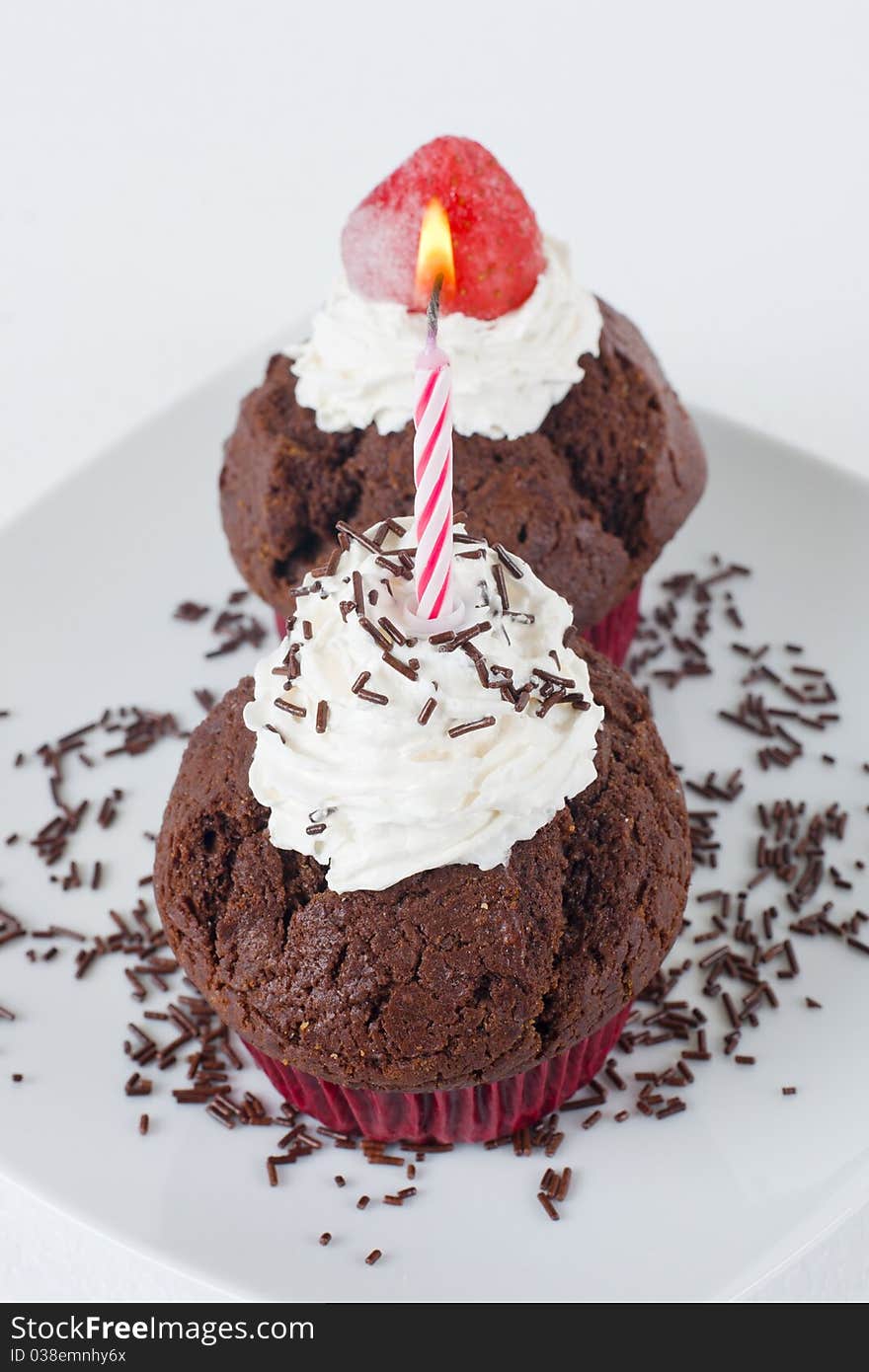 Chocolate muffins with birthday candle. Chocolate muffins with birthday candle.