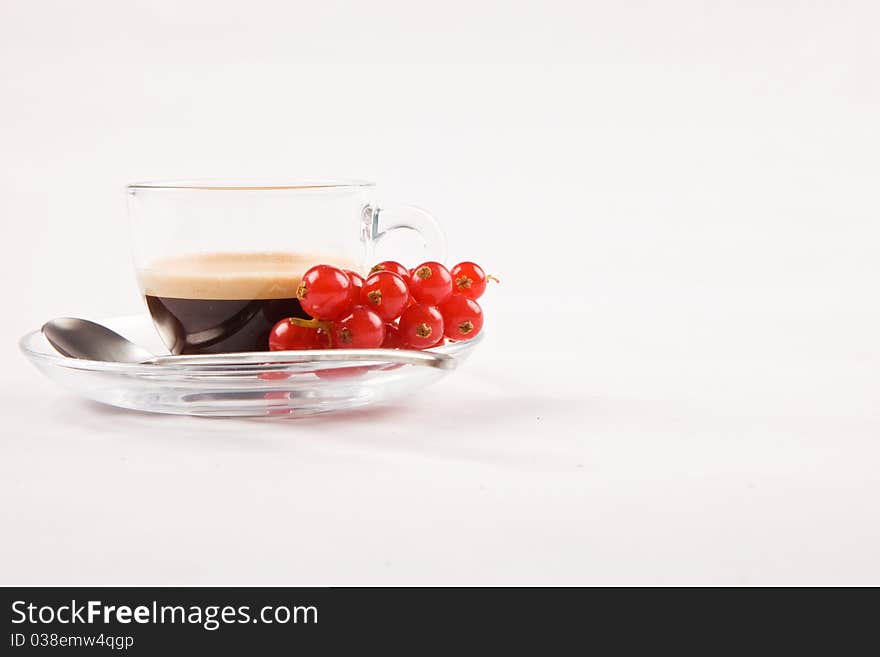 Photo of espresso with currant in glass cup on white isolated background. Photo of espresso with currant in glass cup on white isolated background