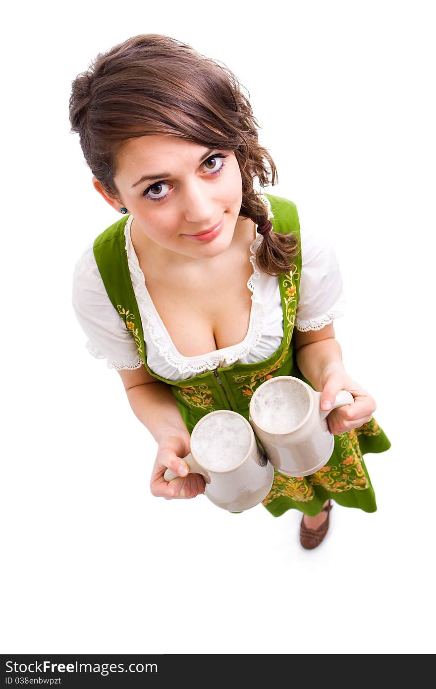 Bavarian girl holding two mugs of beer and smiling. Bavarian girl holding two mugs of beer and smiling