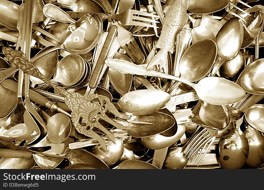 Golden antique spoons and forks as background