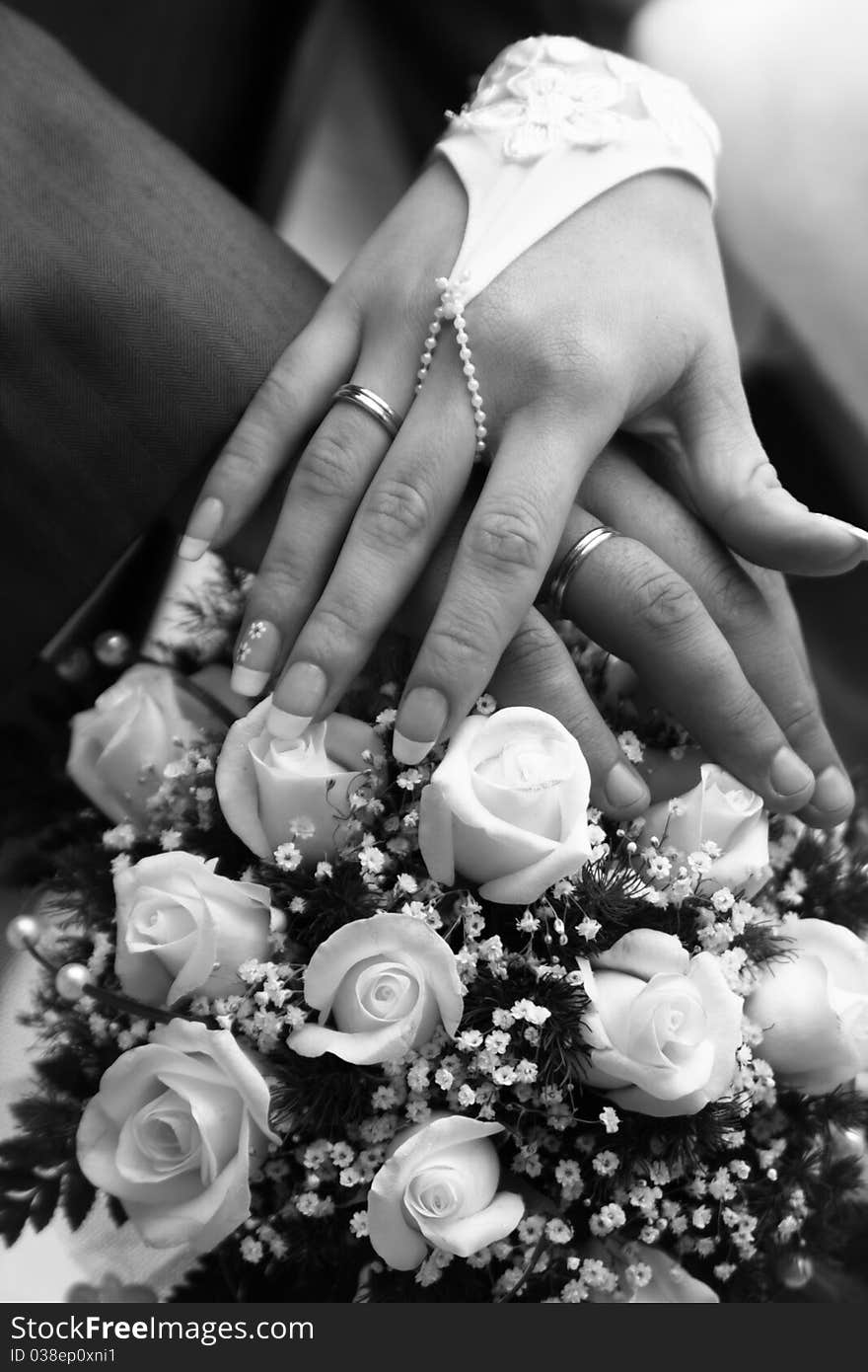 Hands on a background the Wedding bouquet whiht roses