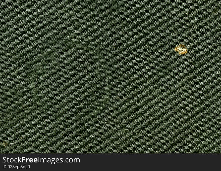 Green leather cover of an antique book with a trace of a hot cup