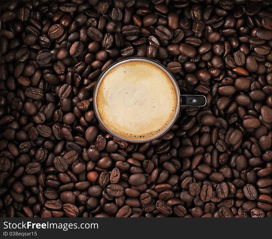 Coffee with cup and cream in coffee beans