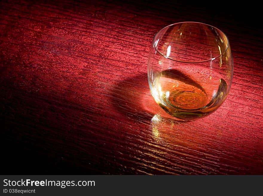 Photo of whiskey on red glasstable