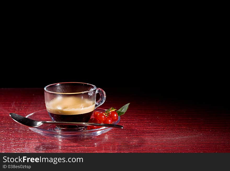 Espresso Coffee With Currants On Red Glasstable