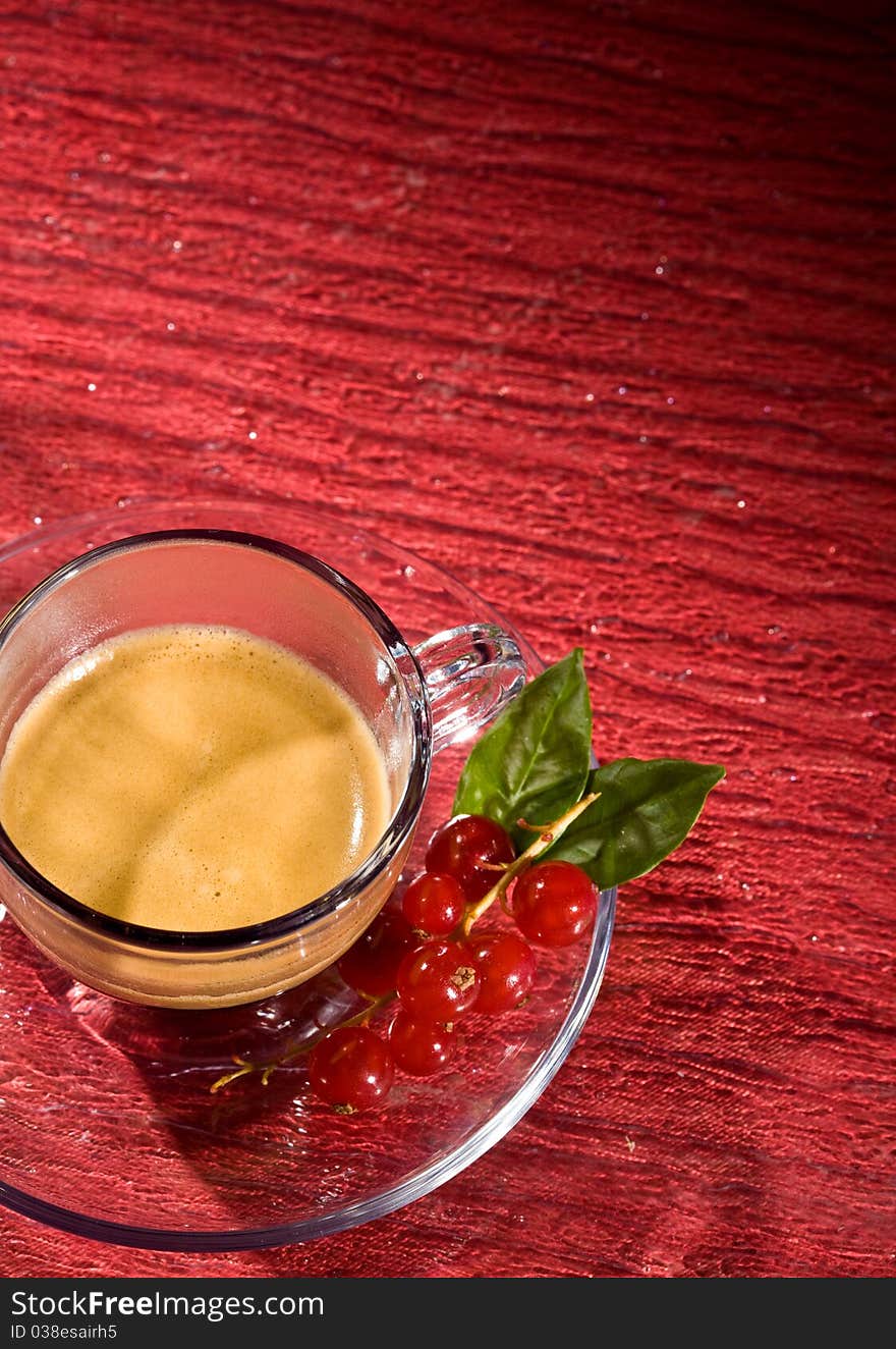 Espresso Coffee With Currants On Red Glasstable