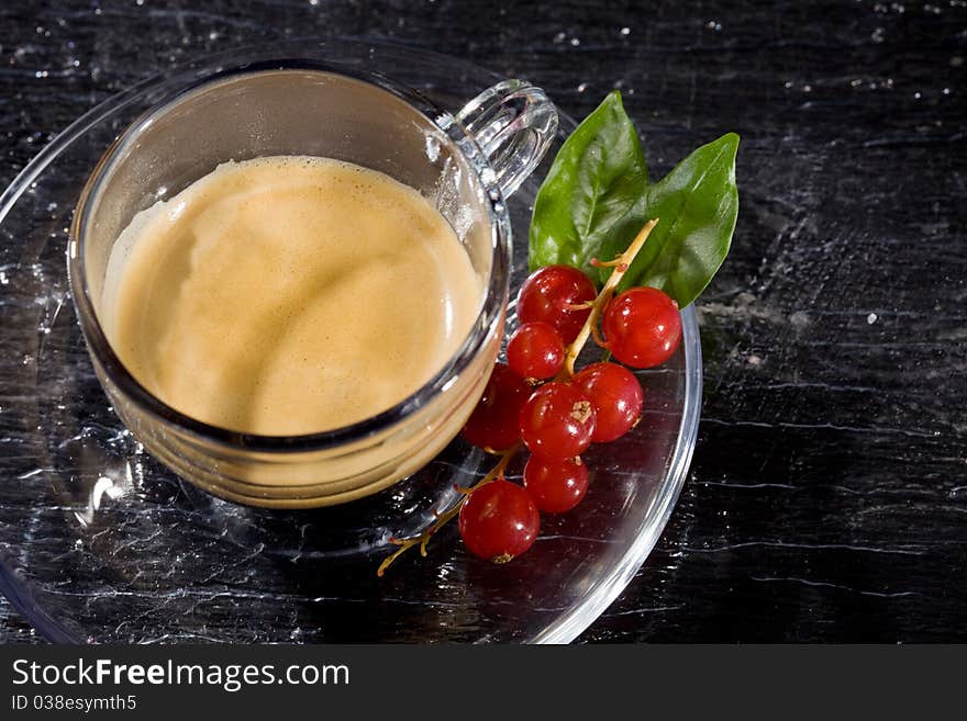 Espresso Cofee With Currants On Black Glass Table