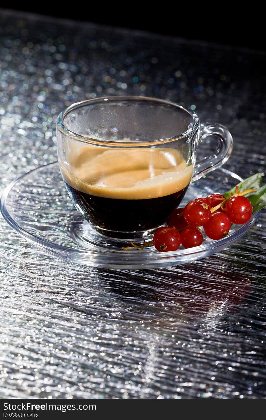 Espresso Cofee With Currants On Black Glass Table