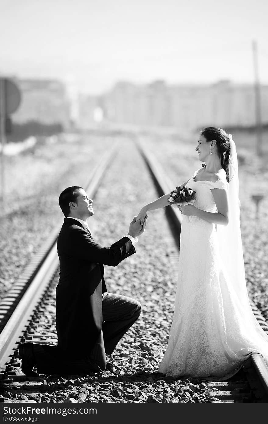 Young just married couple on railway road. Young just married couple on railway road.