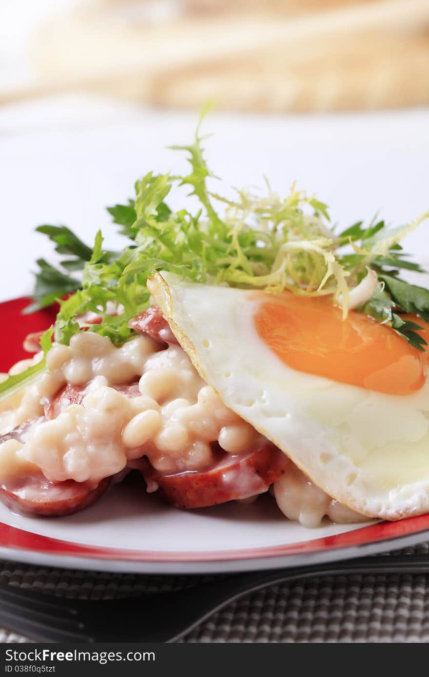 White beans with sausage and fried egg