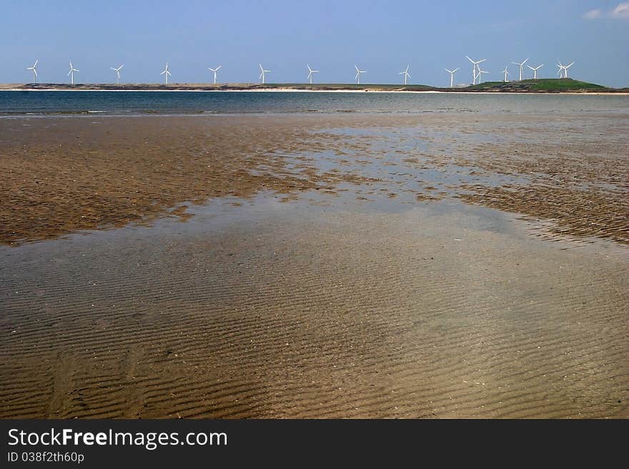 Windmills on coastline