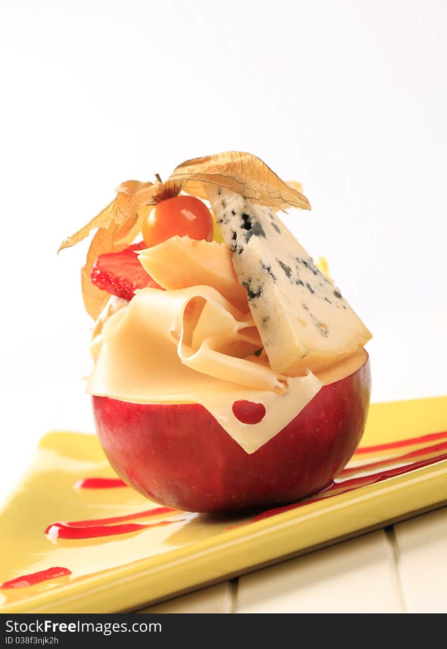 Pieces of cheese on a red apple. Pieces of cheese on a red apple