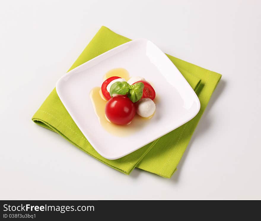 Baby mozzarella cheese balls, tomatoes and basil. Baby mozzarella cheese balls, tomatoes and basil