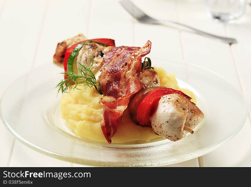 Chicken shish kebab with mashed potato and rasher of bacon. Chicken shish kebab with mashed potato and rasher of bacon