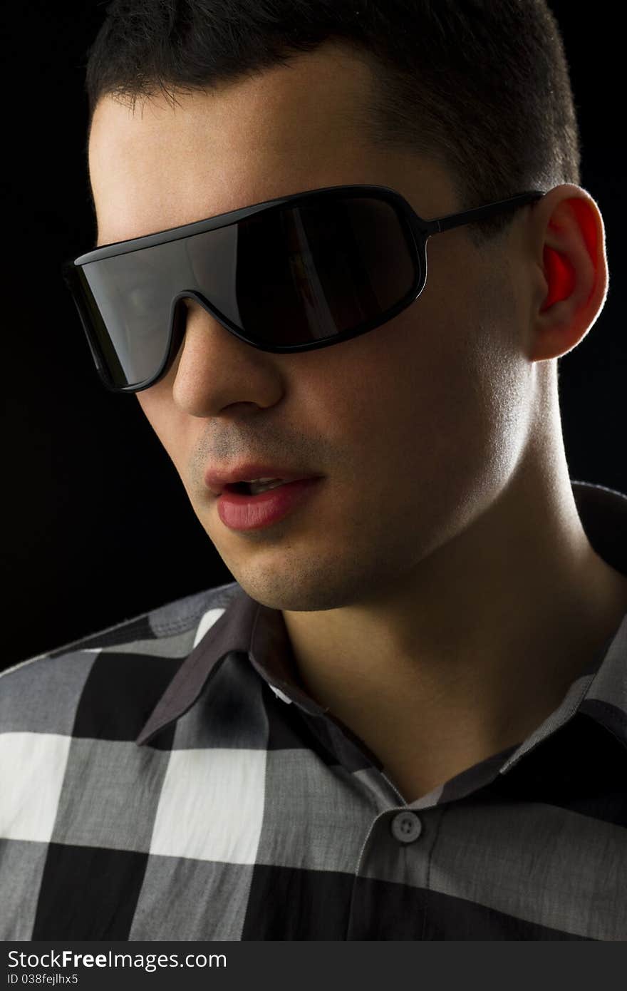 Classic portrait of young man on black background. Classic portrait of young man on black background.