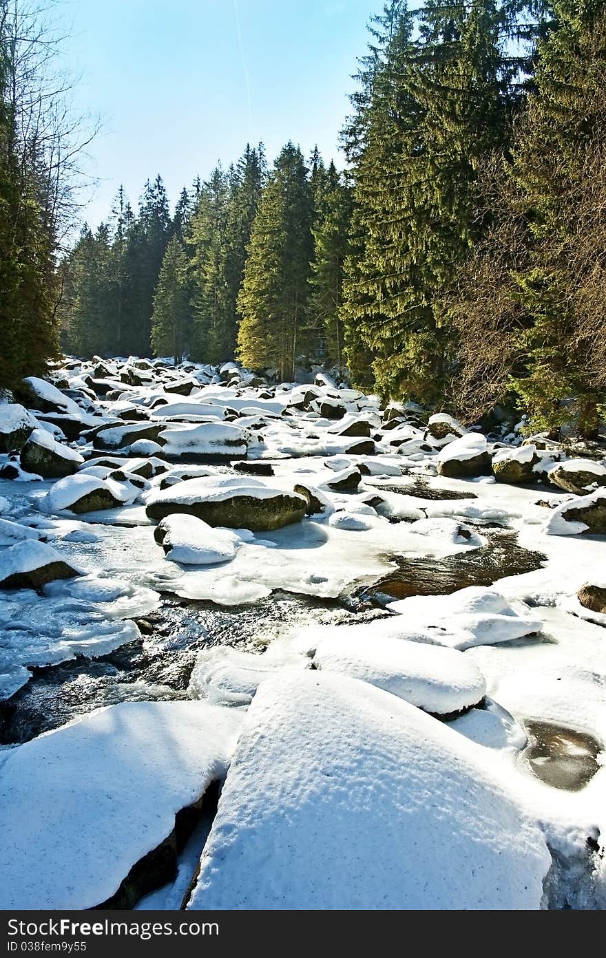 Snow covered river in the mountain