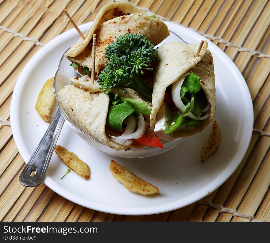 Cheese kathi rolls in plate over wooden background. Cheese kathi rolls in plate over wooden background.