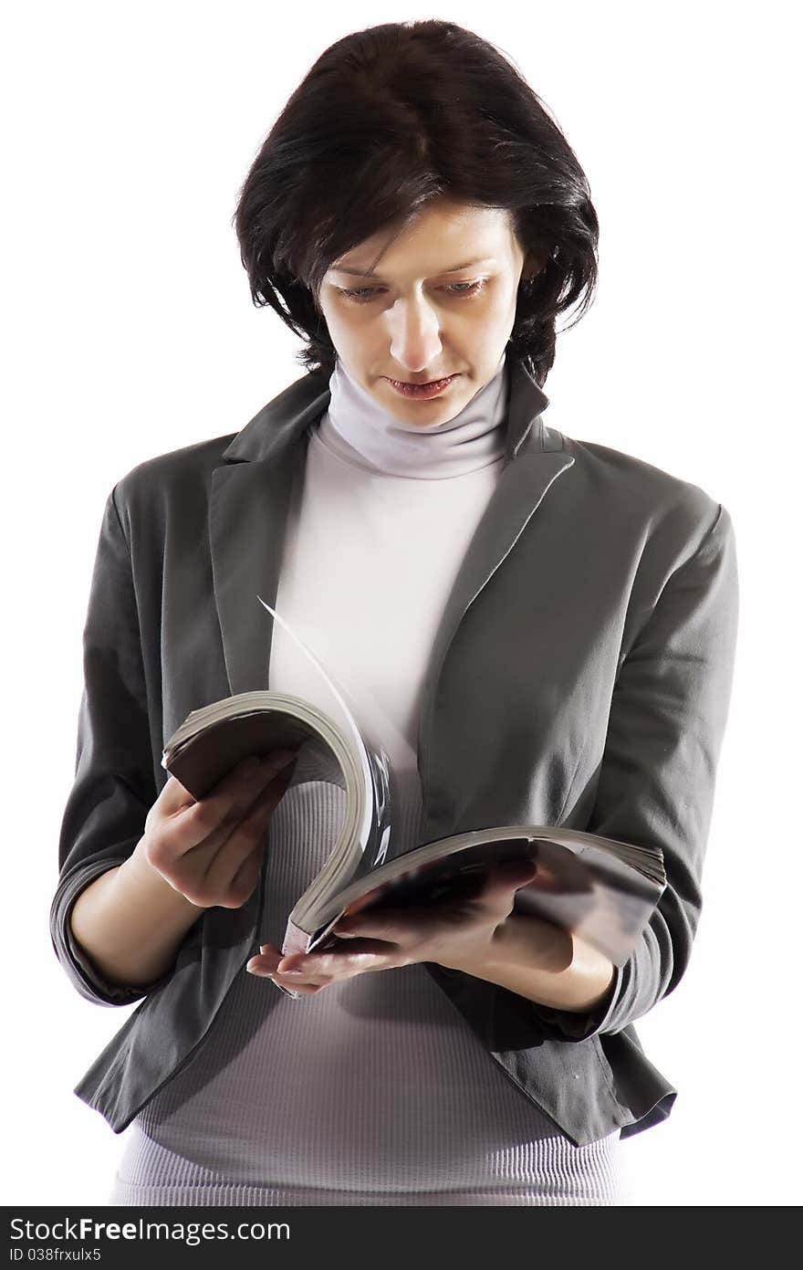 A woman reading a glossy magazine