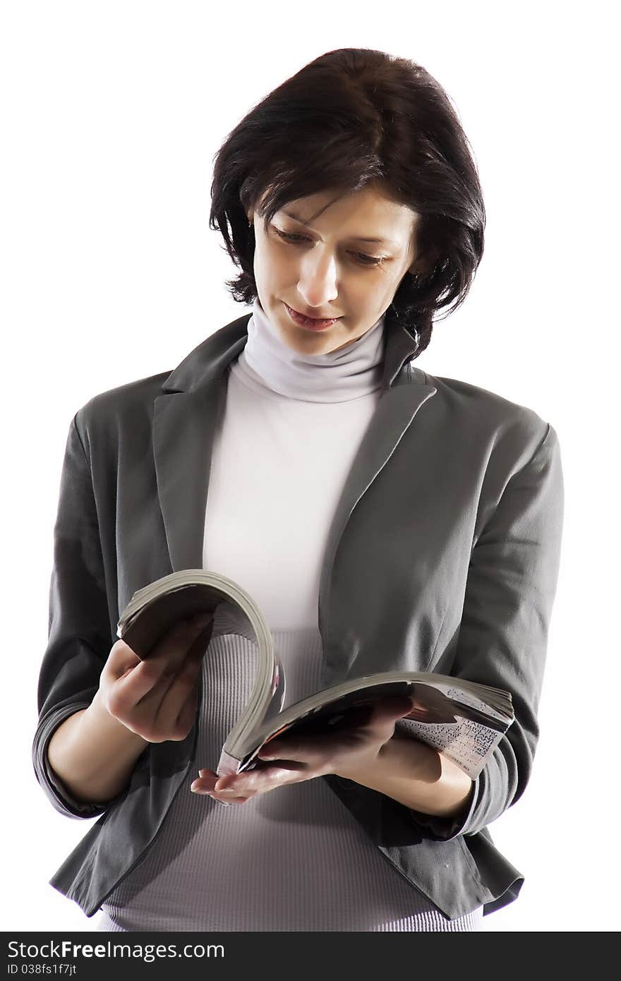 A woman reading a glossy magazine