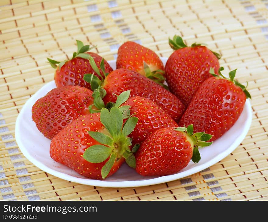 Appetizing large strawberry on a white plate