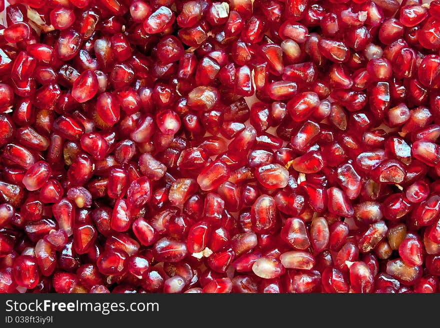 Red ripe grains of pomegranate background