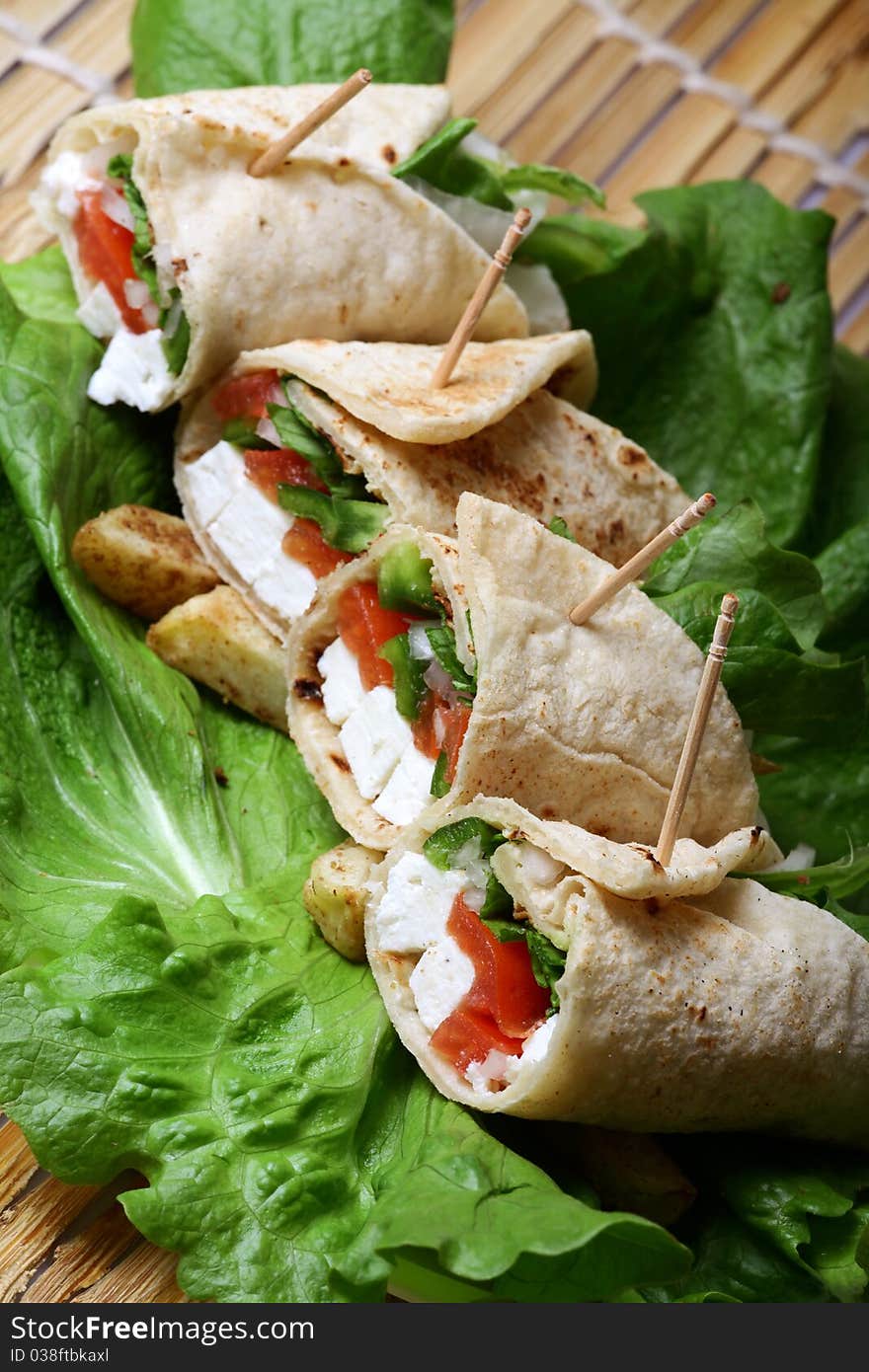 Cheese wraps on letuce leaves looking yummy. Cheese wraps on letuce leaves looking yummy.