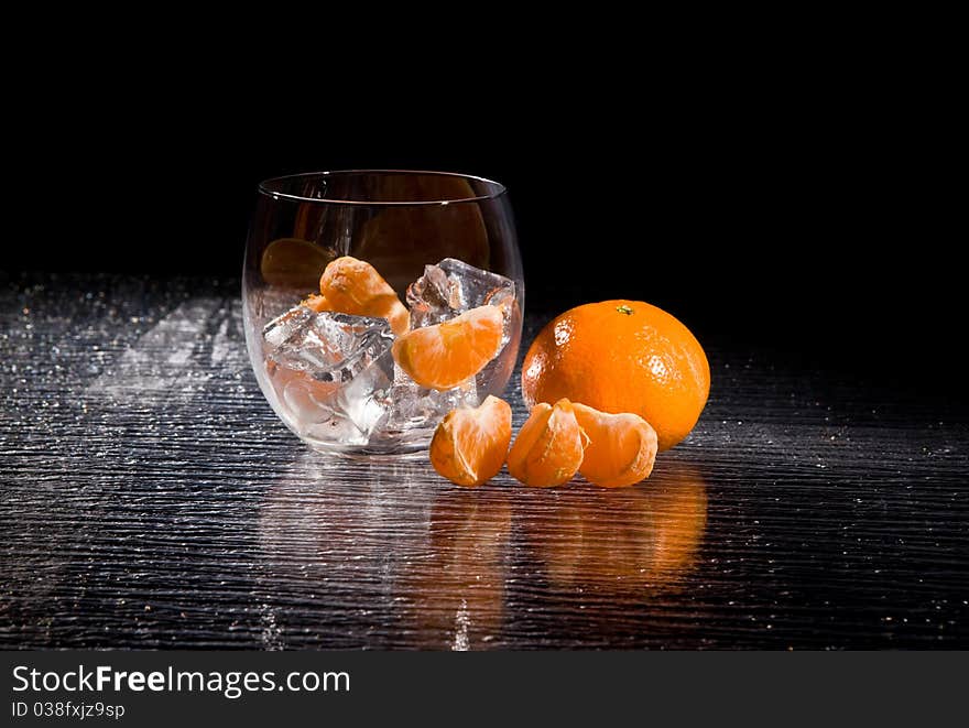 Photo of delicious orange mandarins on ice cubes. Photo of delicious orange mandarins on ice cubes