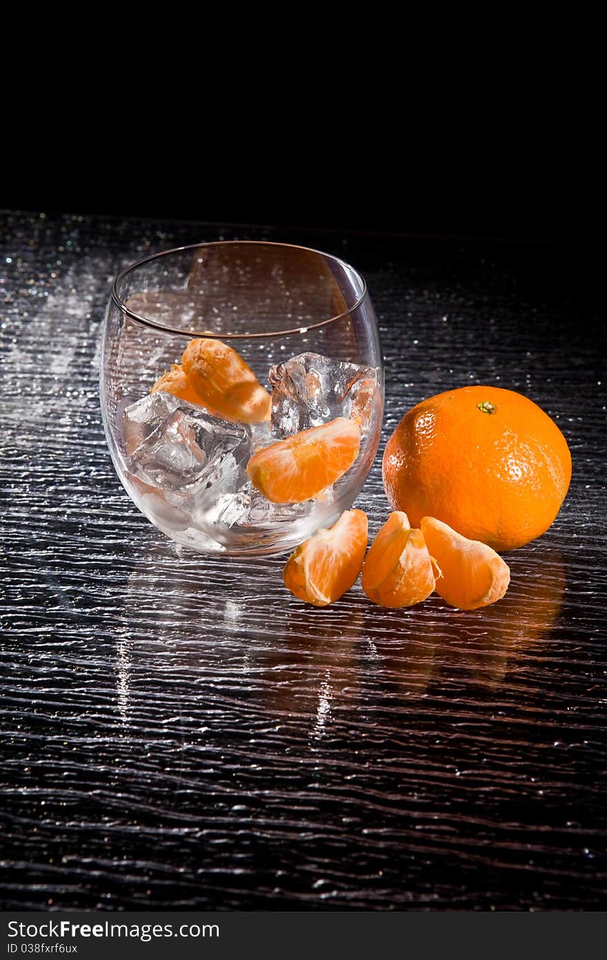 Photo of delicious orange mandarins on ice cubes. Photo of delicious orange mandarins on ice cubes