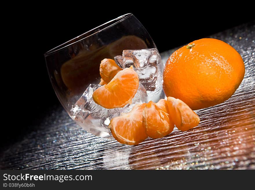 Photo of delicious orange mandarins on ice cubes. Photo of delicious orange mandarins on ice cubes