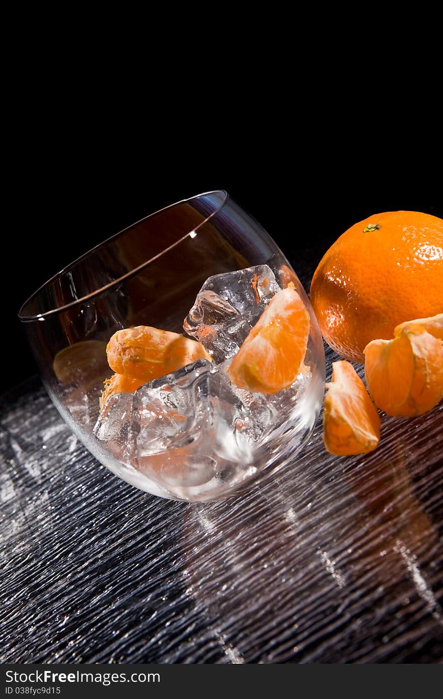 Photo of delicious orange mandarins on ice cubes. Photo of delicious orange mandarins on ice cubes