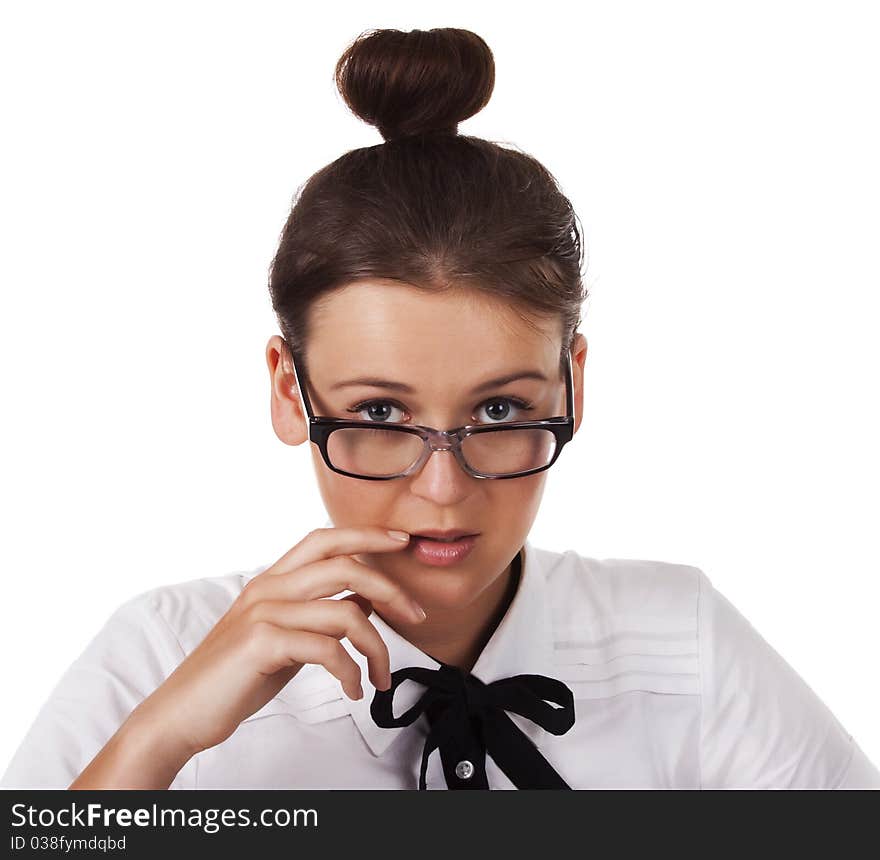 Girl with glasses holds a hand near the mouth on a white background