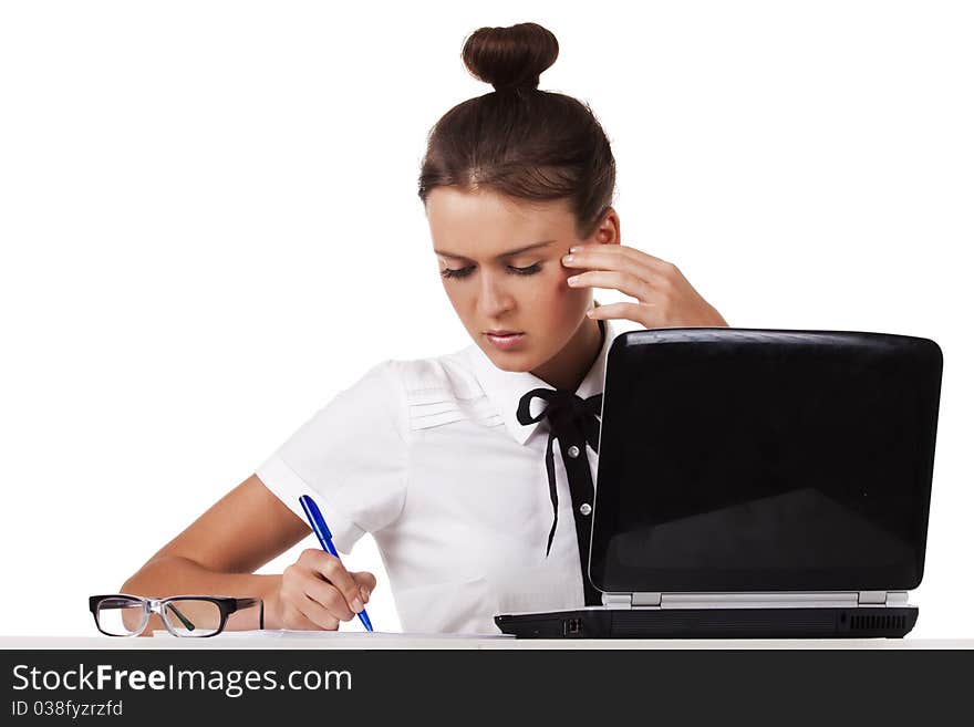 Young Woman  Sitting At A Table Taking Notes