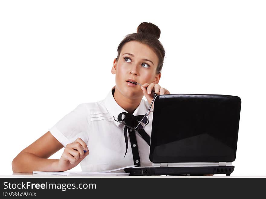 Young woman  sitting at a table taking notes