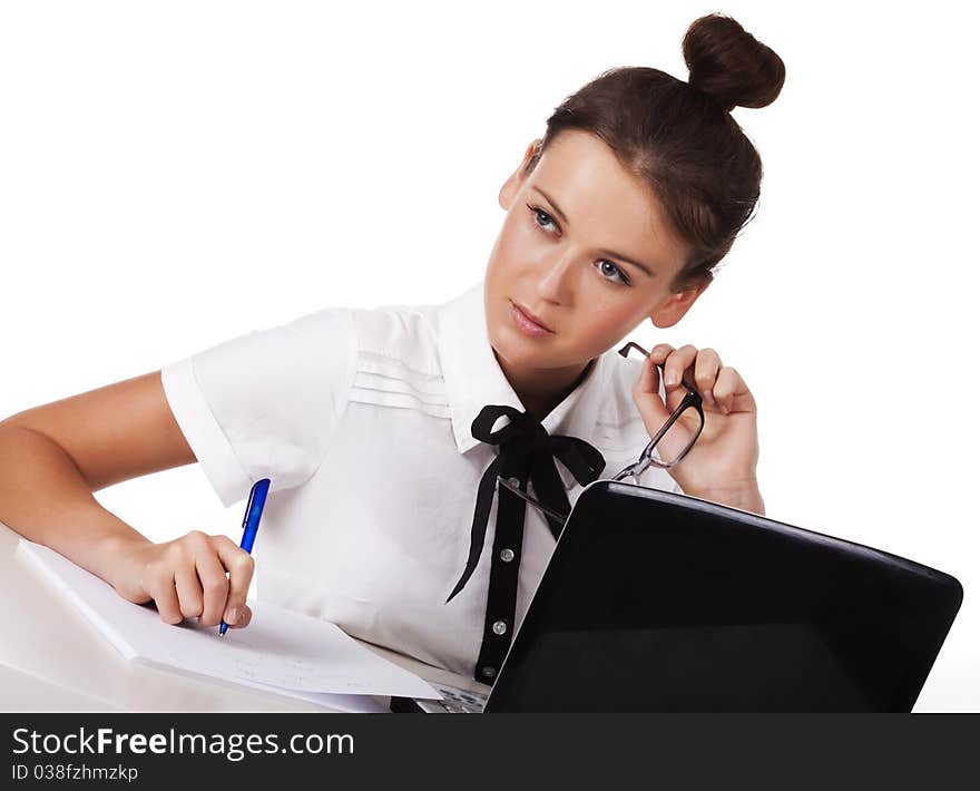 Young woman sitting at a table taking notes