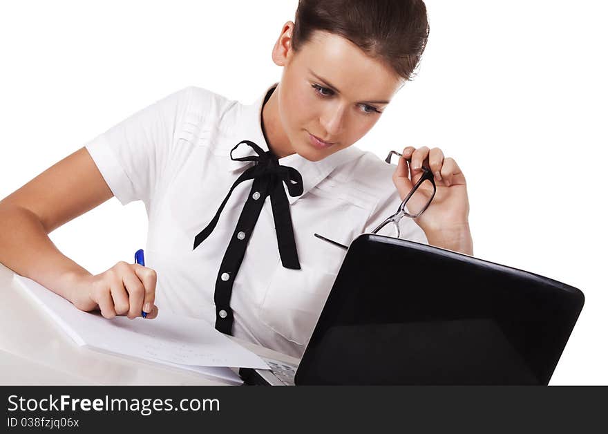 Young woman sitting at a table taking notes