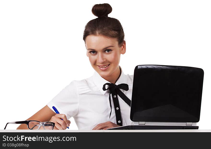 Young Woman  Sitting At A Table Taking Notes