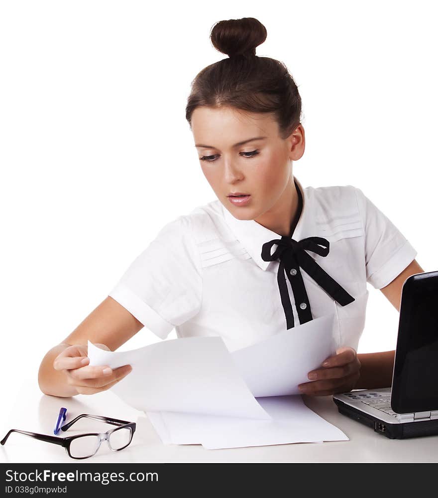 Woman sitting behind a desk through the documents