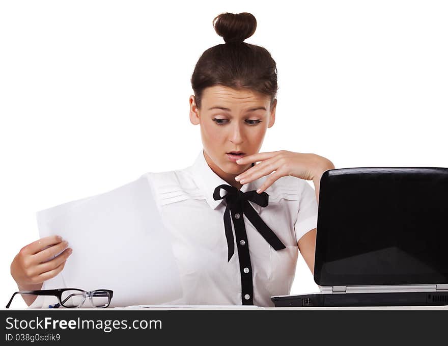 Woman sitting behind a desk through the documents