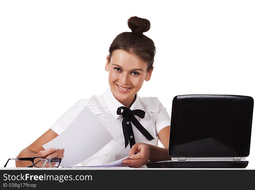 Woman sitting behind a desk through the documents