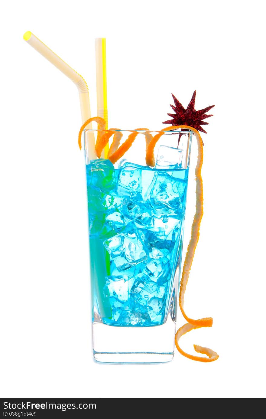 Classic Blue Hawaiian Cocktail with vodka, light rum, gin, tequila, blue curacao, lime juice, lemonade, two yellow striped straws, twisted orange and christmas star isolated on a white background. Classic Blue Hawaiian Cocktail with vodka, light rum, gin, tequila, blue curacao, lime juice, lemonade, two yellow striped straws, twisted orange and christmas star isolated on a white background