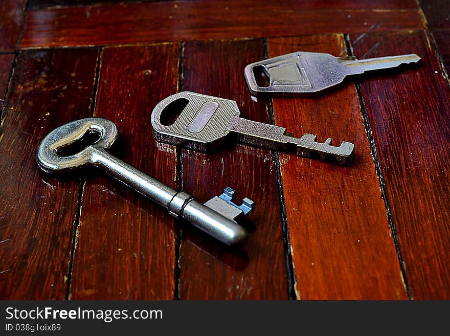 Three different key on the wood floor. Three different key on the wood floor