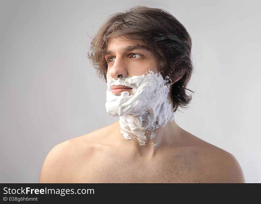 Young man with shaving cream on his face. Young man with shaving cream on his face