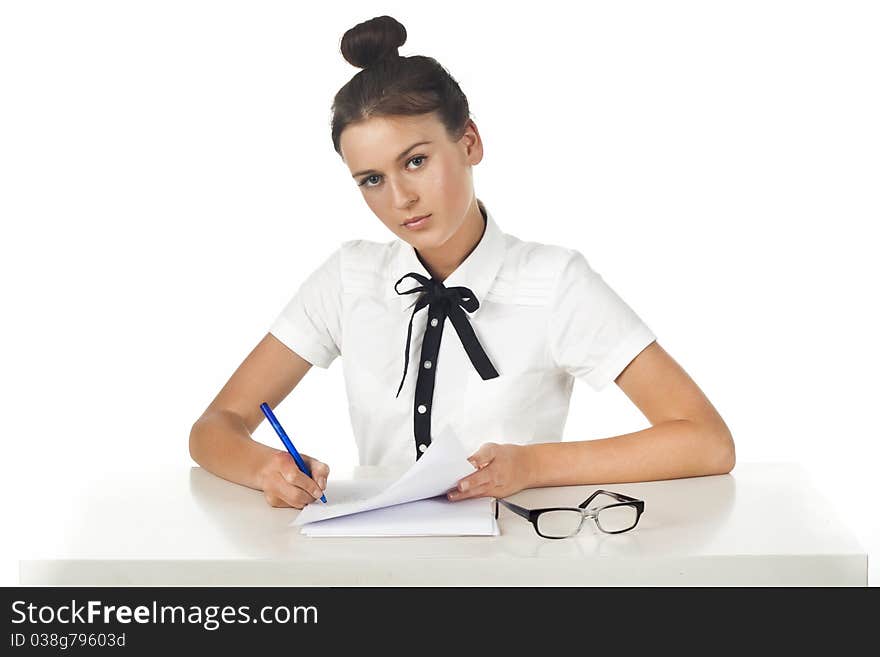 Brunette sitting at the table working with documents and thoughtful. A series of friendly office. Brunette sitting at the table working with documents and thoughtful. A series of friendly office